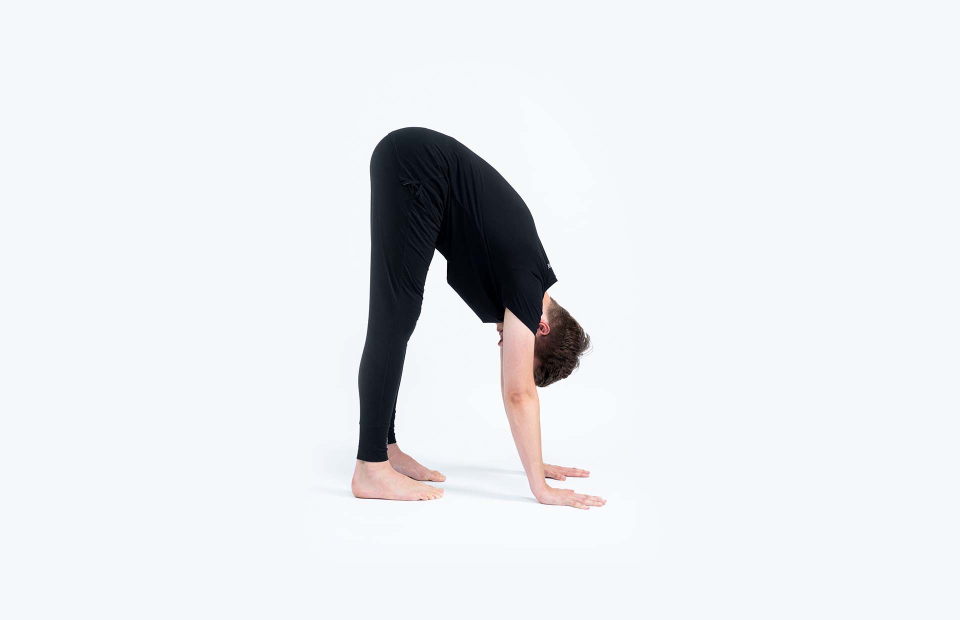 A person bending forward into Uttanasana