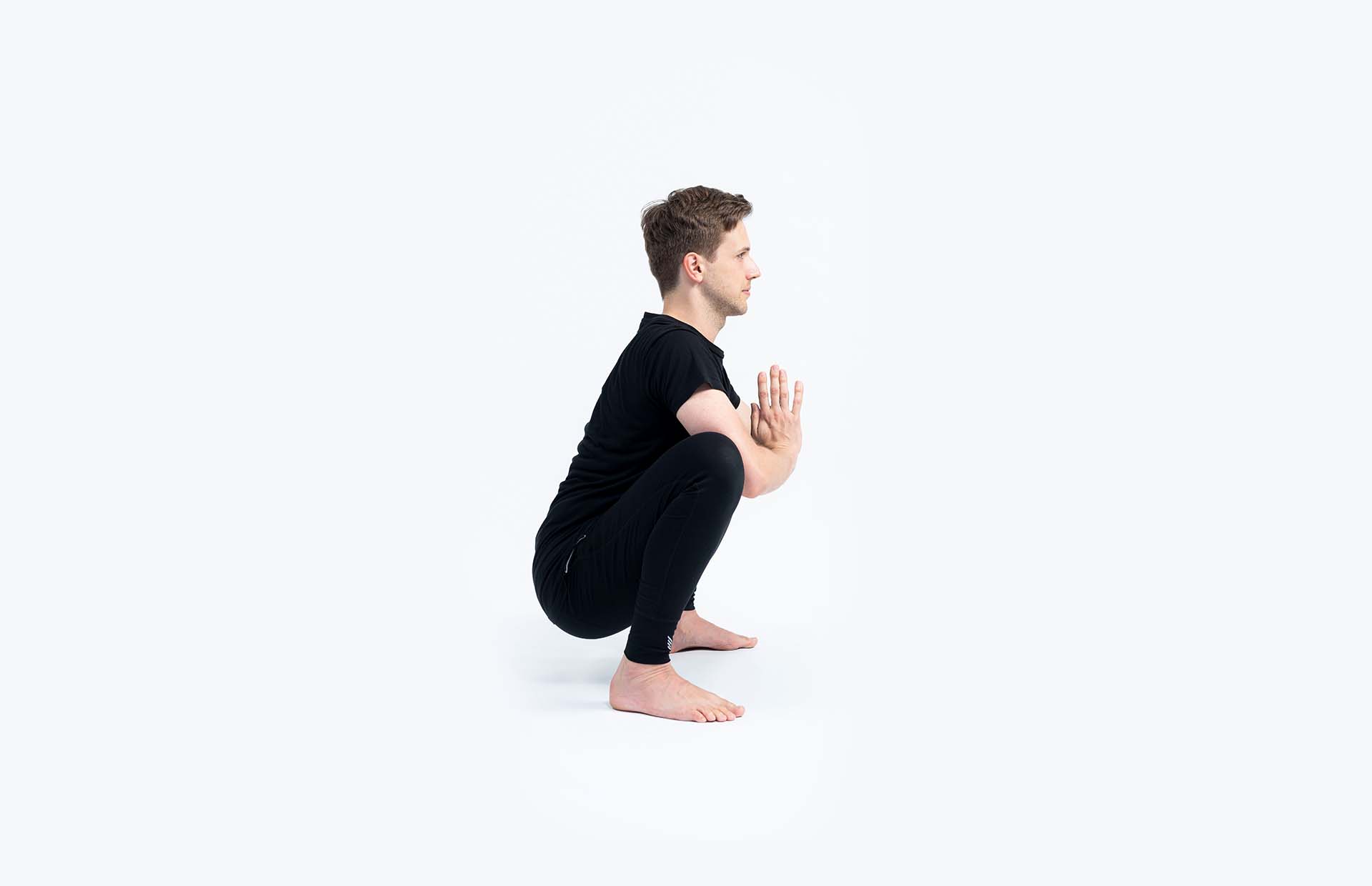 A person in Malasana (Squat)