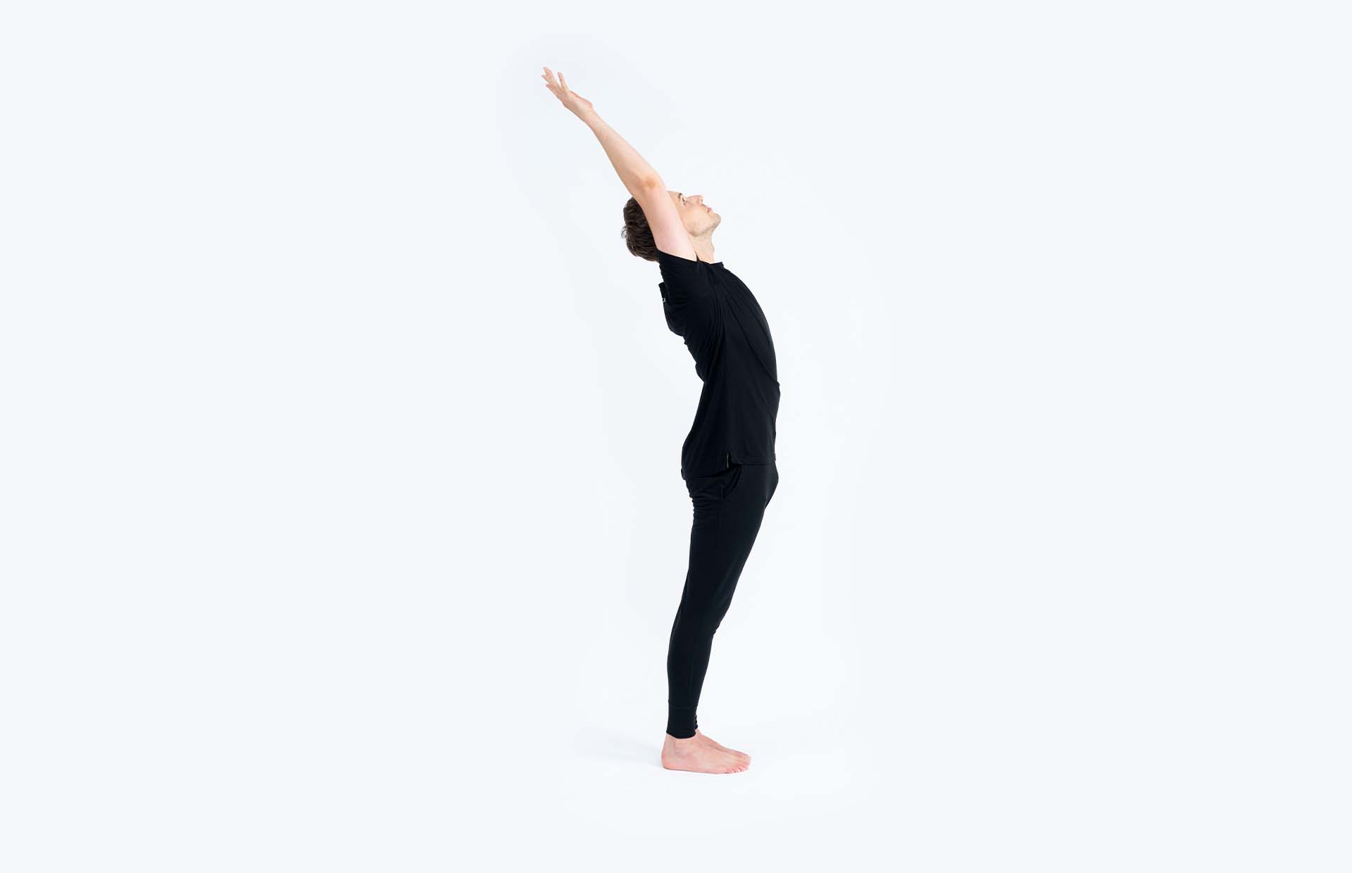 A person arching back with hooked thumbs overhead