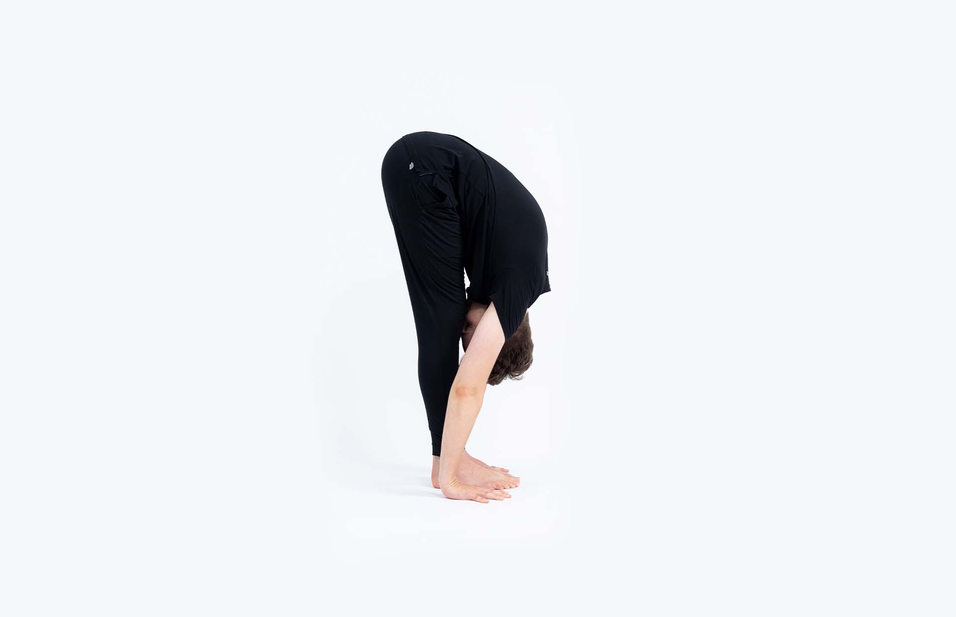 A person folding forward (Uttanasana)