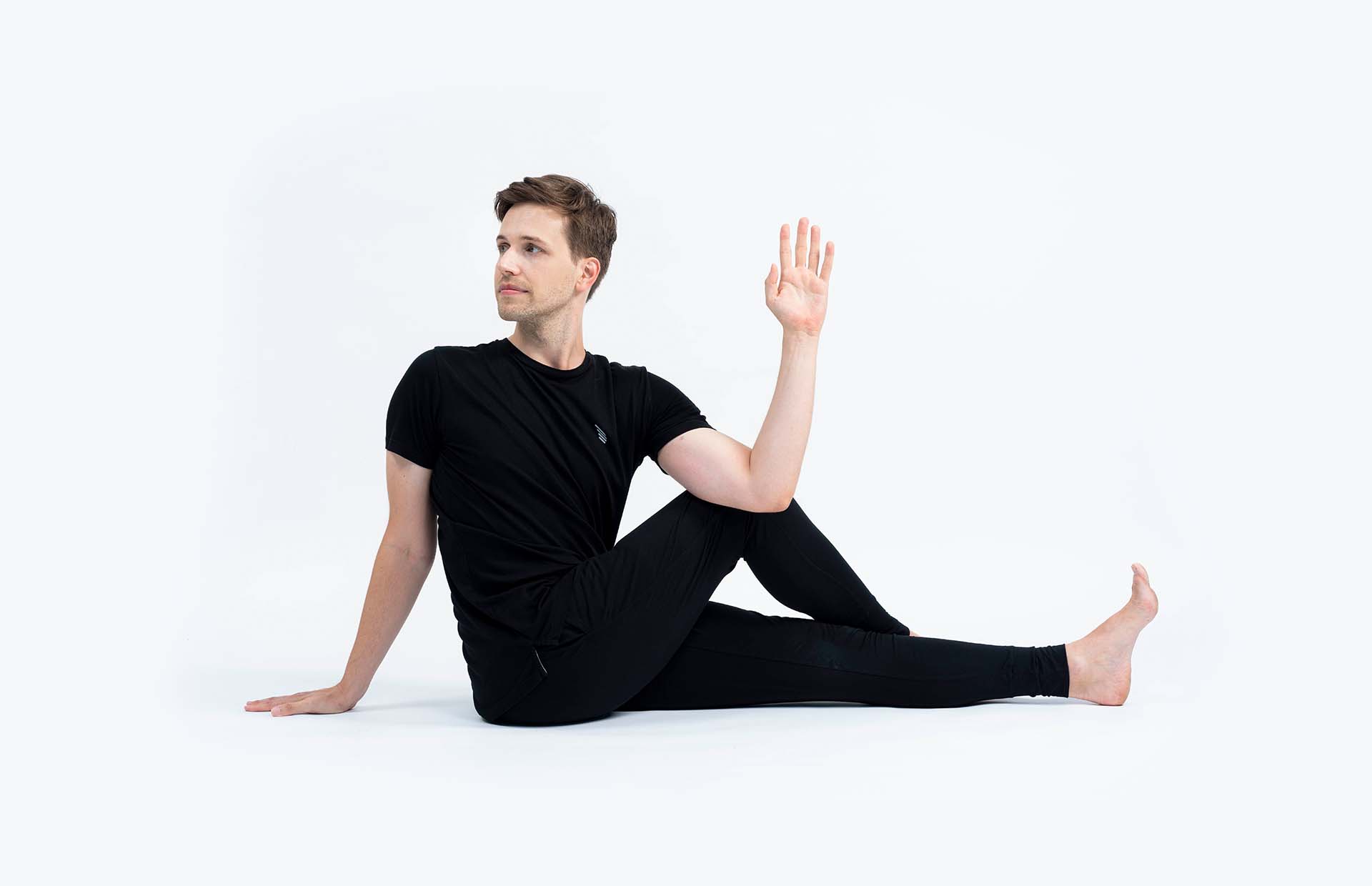 A person twisting in Ardha Matsyendrasana (Seated Twist)