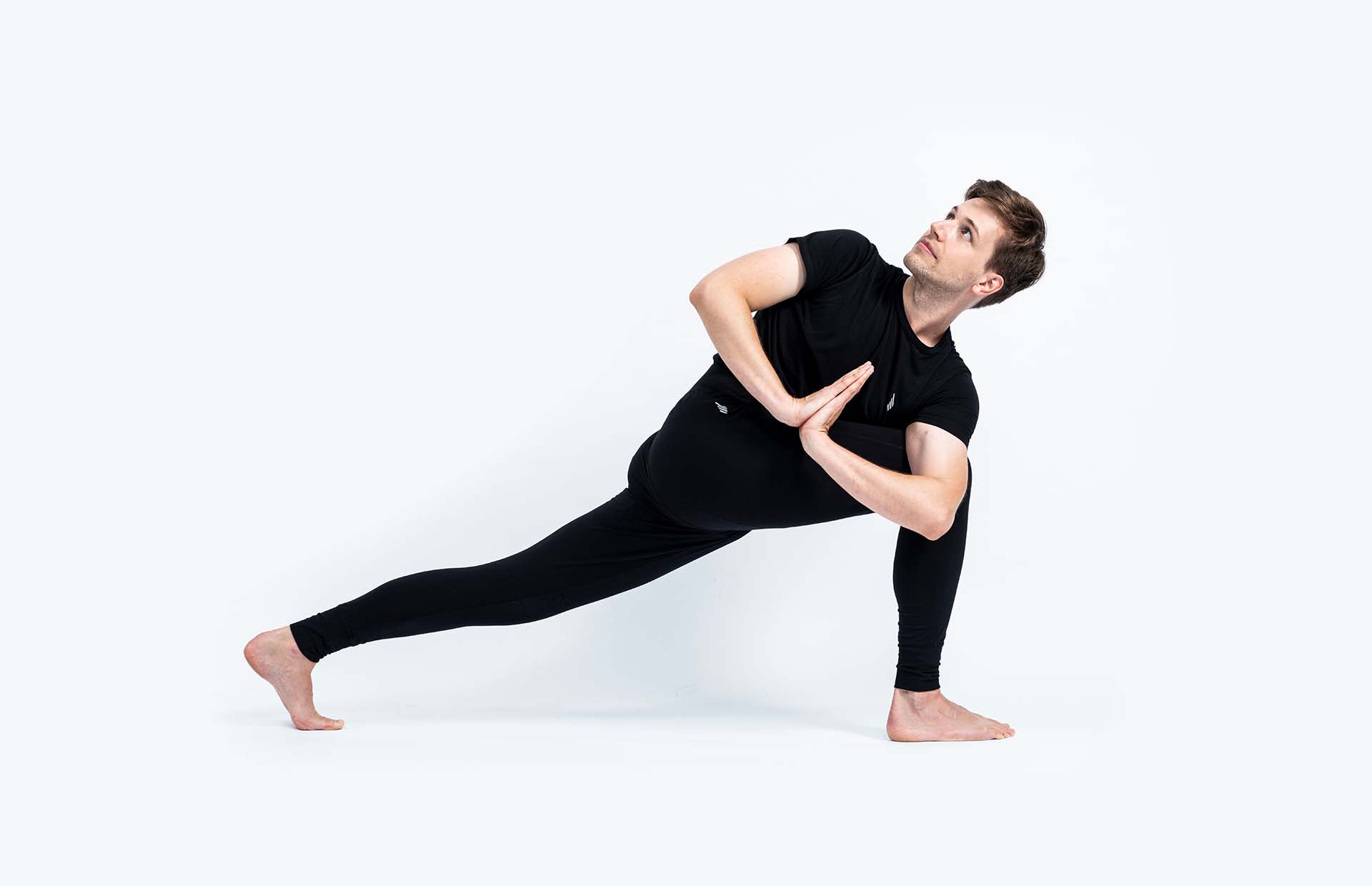 A person twisting in Parivrtta Parsvakonasana (Revolved Side Angle Pose)