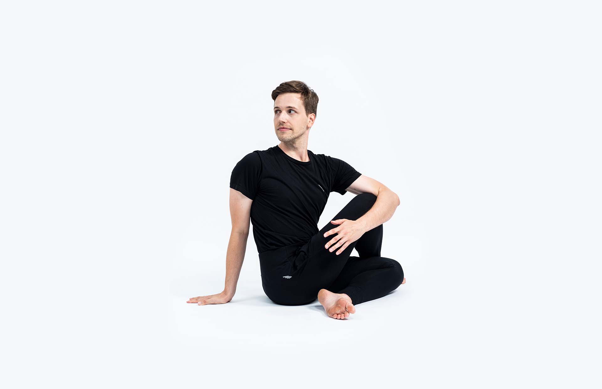 A person twisting in Ardha Matsyendrasana (Seated Spinal Twist)
