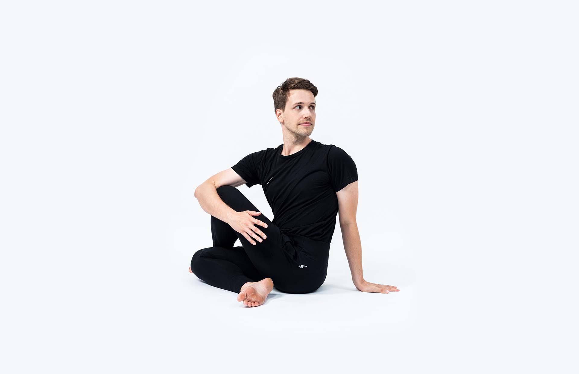 A person in Ardha Matsyendrasana (Seated Twist)