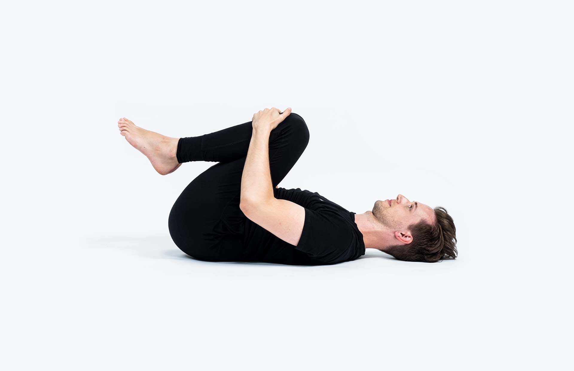 A person drawing in their knees to their chest