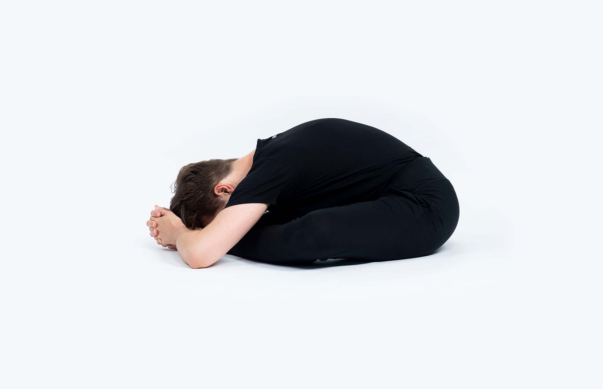 A person reaching into Tarasana
