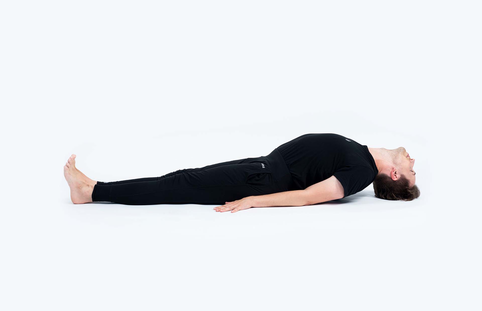 A person extending into Matsyasana (Fish Pose)